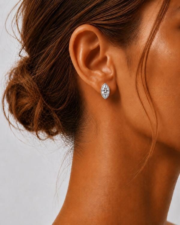 Marquise diamond bezel stud in white gold, worn on the ear