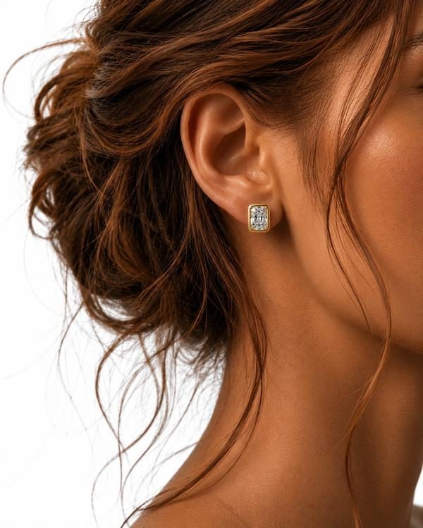 Radiant cut diamond bezel stud in yellow gold, worn on the ear