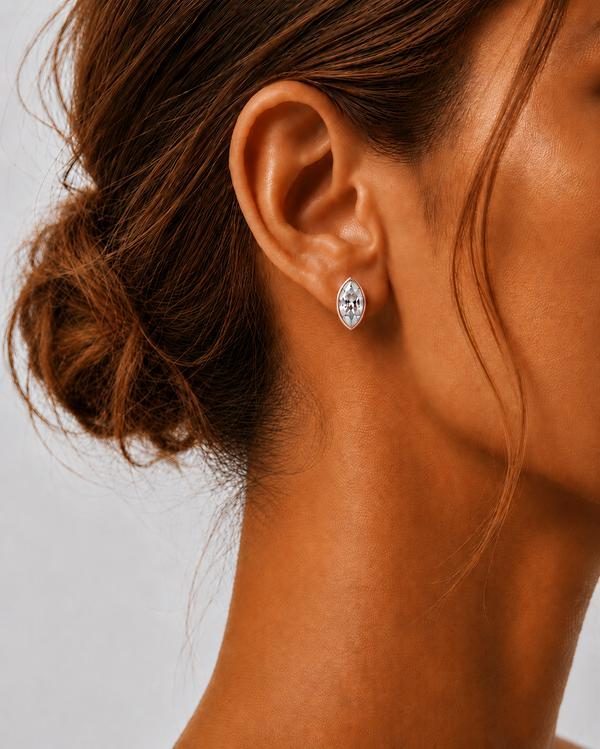 Marquise diamond bezel stud in rose gold, worn on the ear