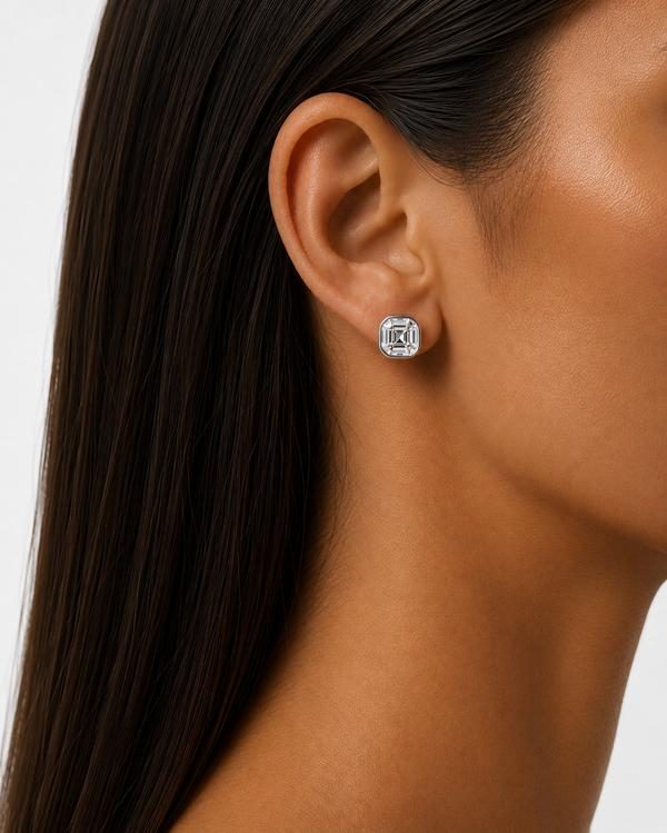 Asscher cut diamond bezel stud in white gold, worn on the ear