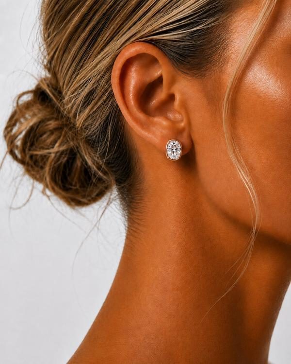 Cushion cut diamond bezel stud in rose gold, worn on the ear
