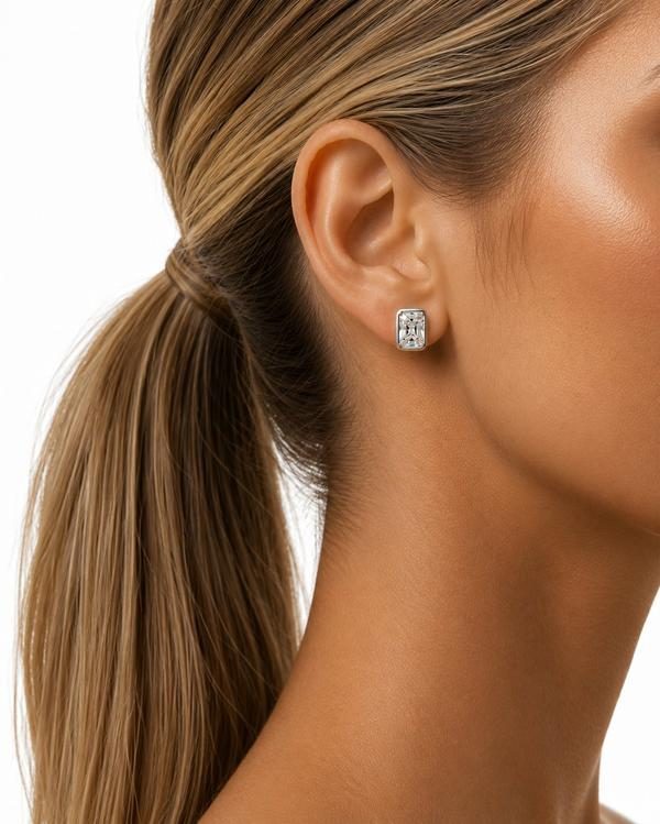 Radiant cut diamond bezel stud in white gold, worn on the ear